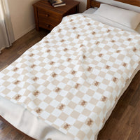 cozy gingerbread cookie pattern with white and beige checker blanket, theme park christmas blanket